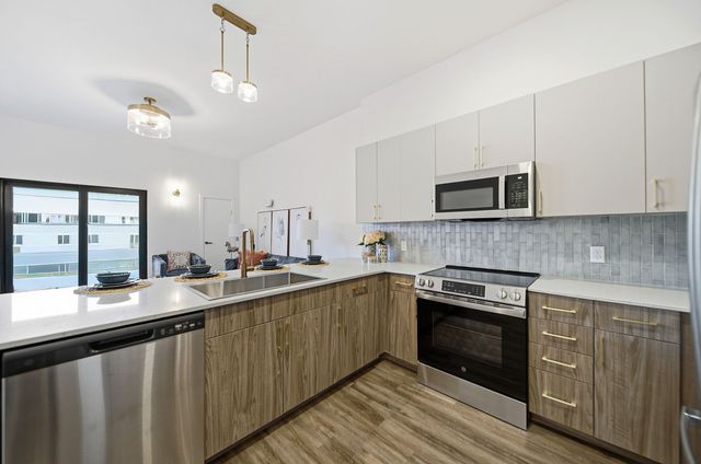 Open-concept kitchen and dining area in a Webster Station Flats apartment
